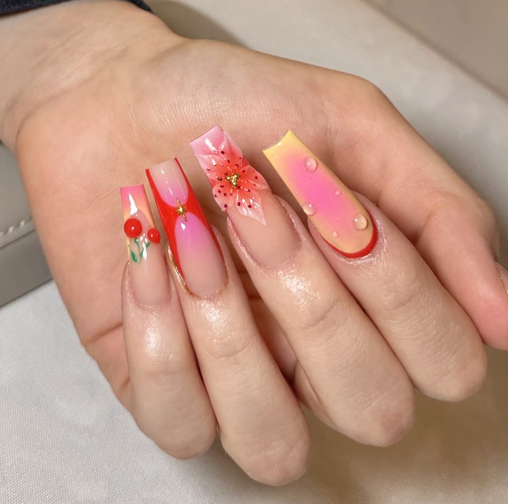 Coral and pink ombre coffin nails with a 3D flower and gold detail