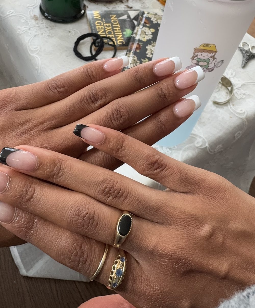 Almond nails with pink airbrushed blossoms and fine black line art